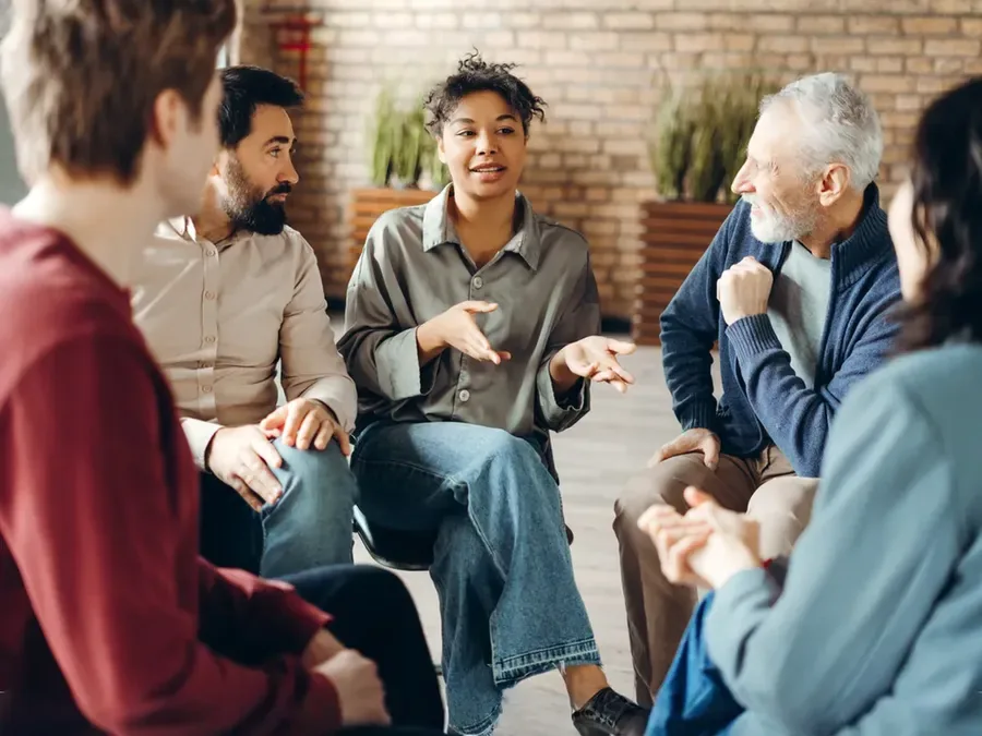 A small group talking together in a living room